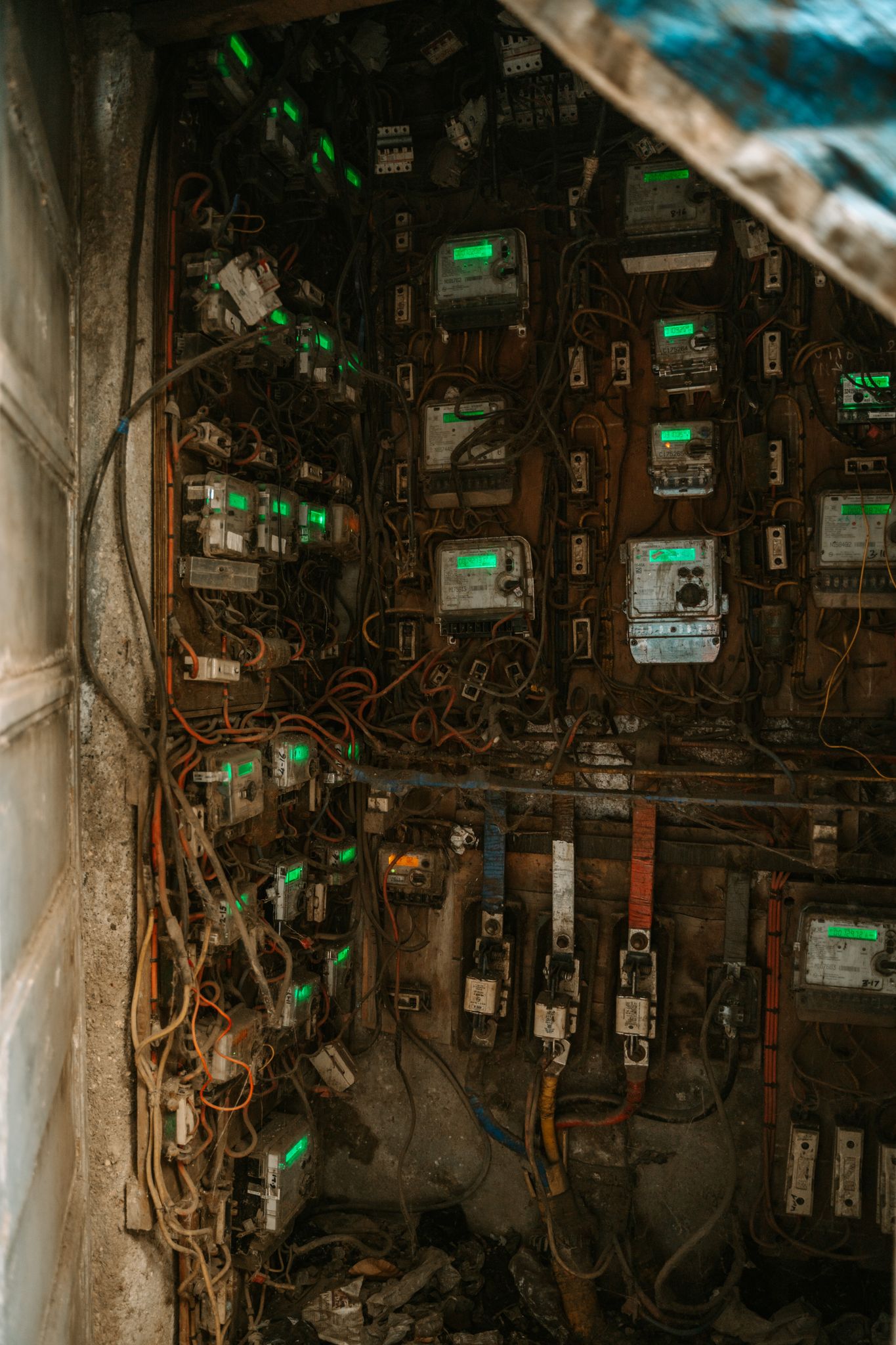Intricate close-up of a tangled electrical panel with multiple meters and wires.